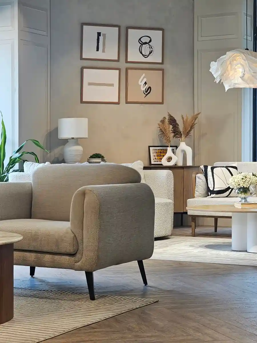 Dark atmospheric ROAR Interiors studio with an arched window, wooden desk and vintage chair
